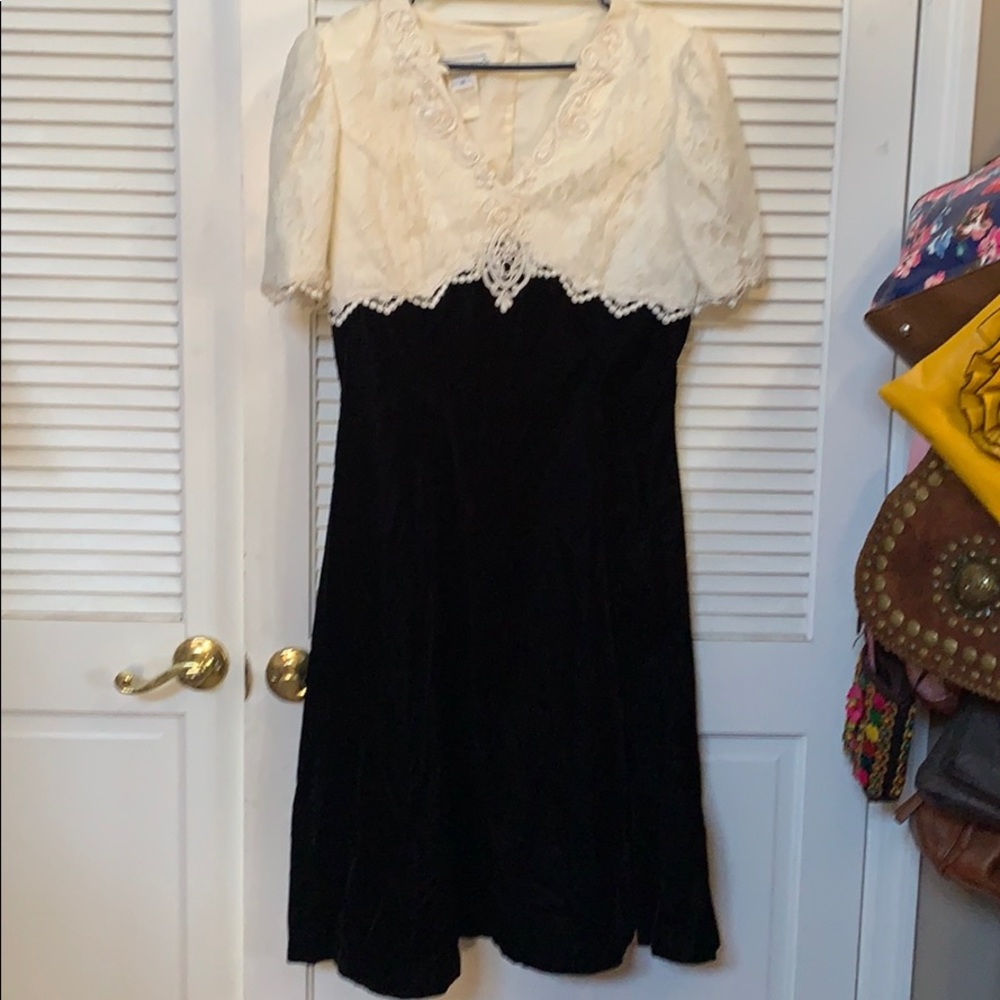 Black and lace dress with pearl accents.